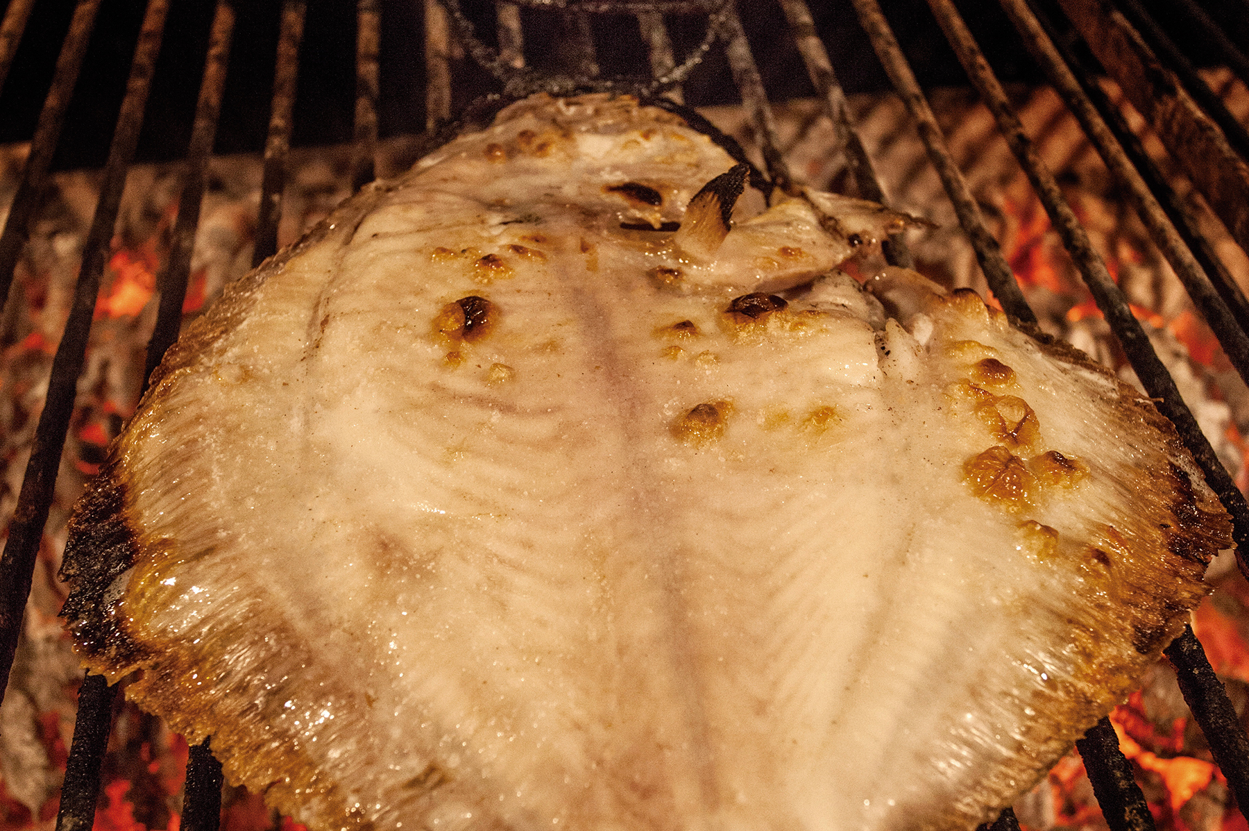 Turbot in its basket over the embers